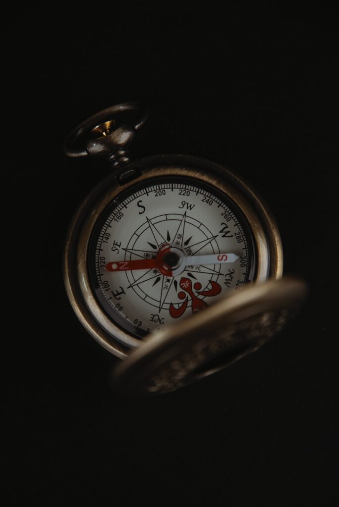 a close up of a compass in the dark